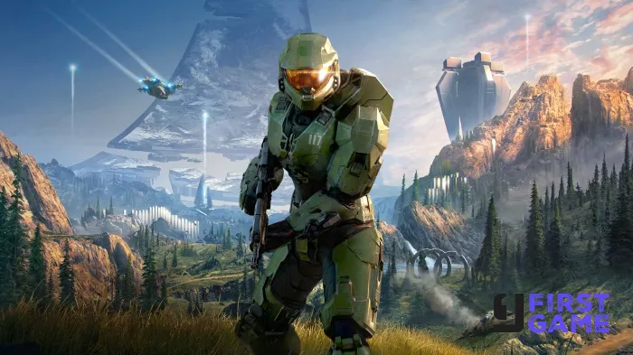 A green armored soldier crouches with a rifle in a rugged valley, futuristic structures visible in the distance under a blue sky.